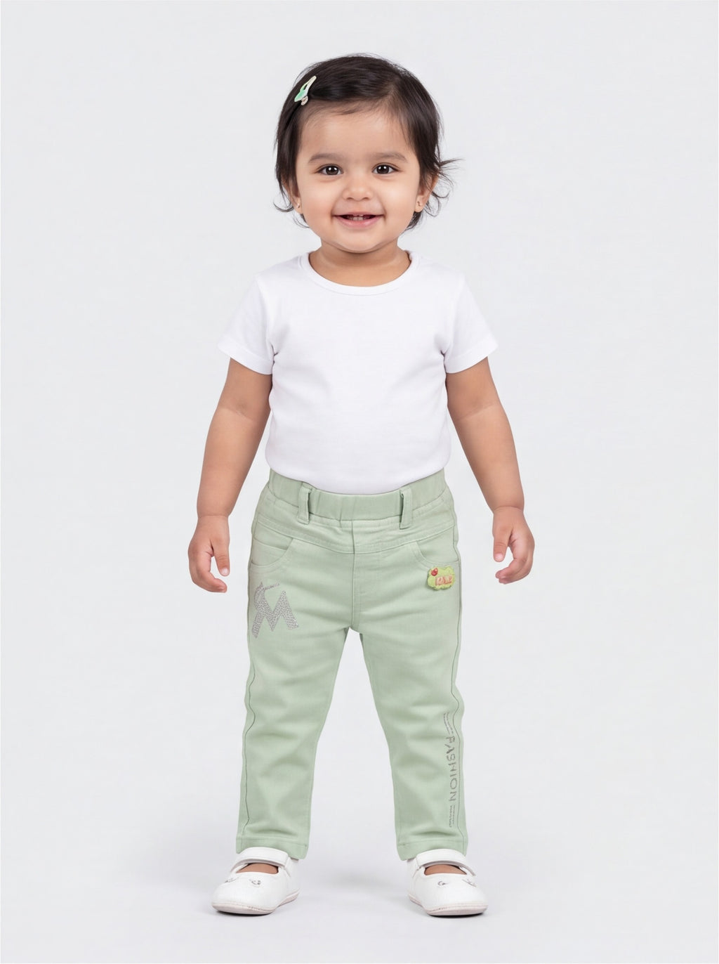 Front view of mint green cotton denim pants for baby girls
